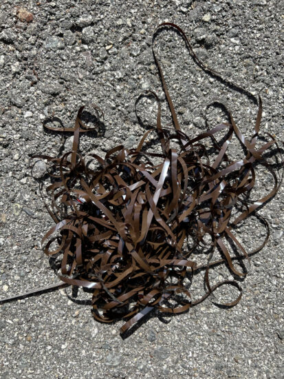 a tangle of tape on concrete sidewalk