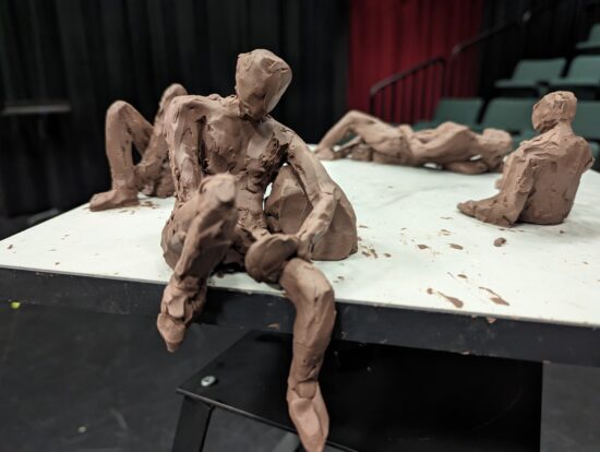 Clay figure sitting on the edge of a table