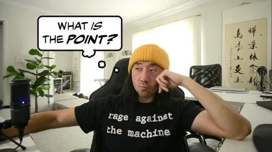 Ge Wang wearing a “Rage Against the Machine” t-shirt sits and looks to the side; a thought-bubble next to him reads, “What is the point?”