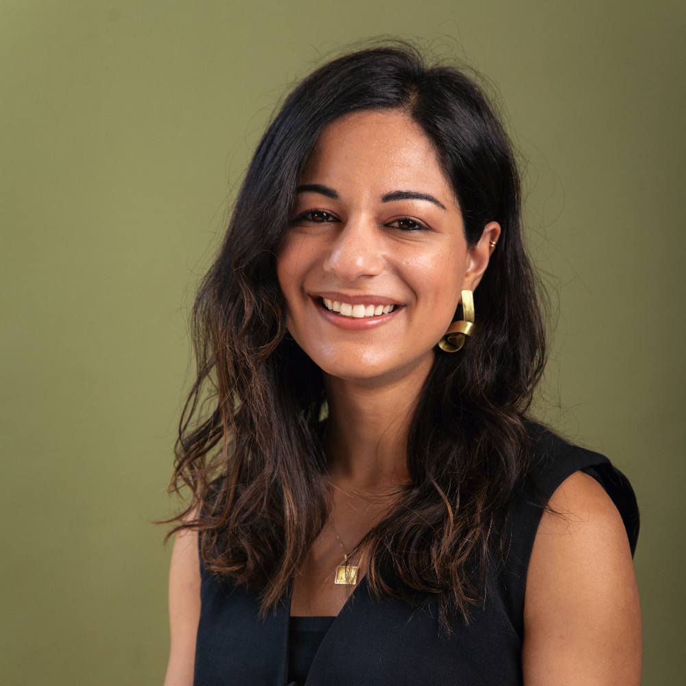 Roxanne Rahnama Hazaveh, headshot of person with large gold earing looking at camera