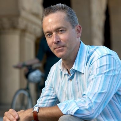 A photo of Gavin Jones in a light blue and white striped shirt