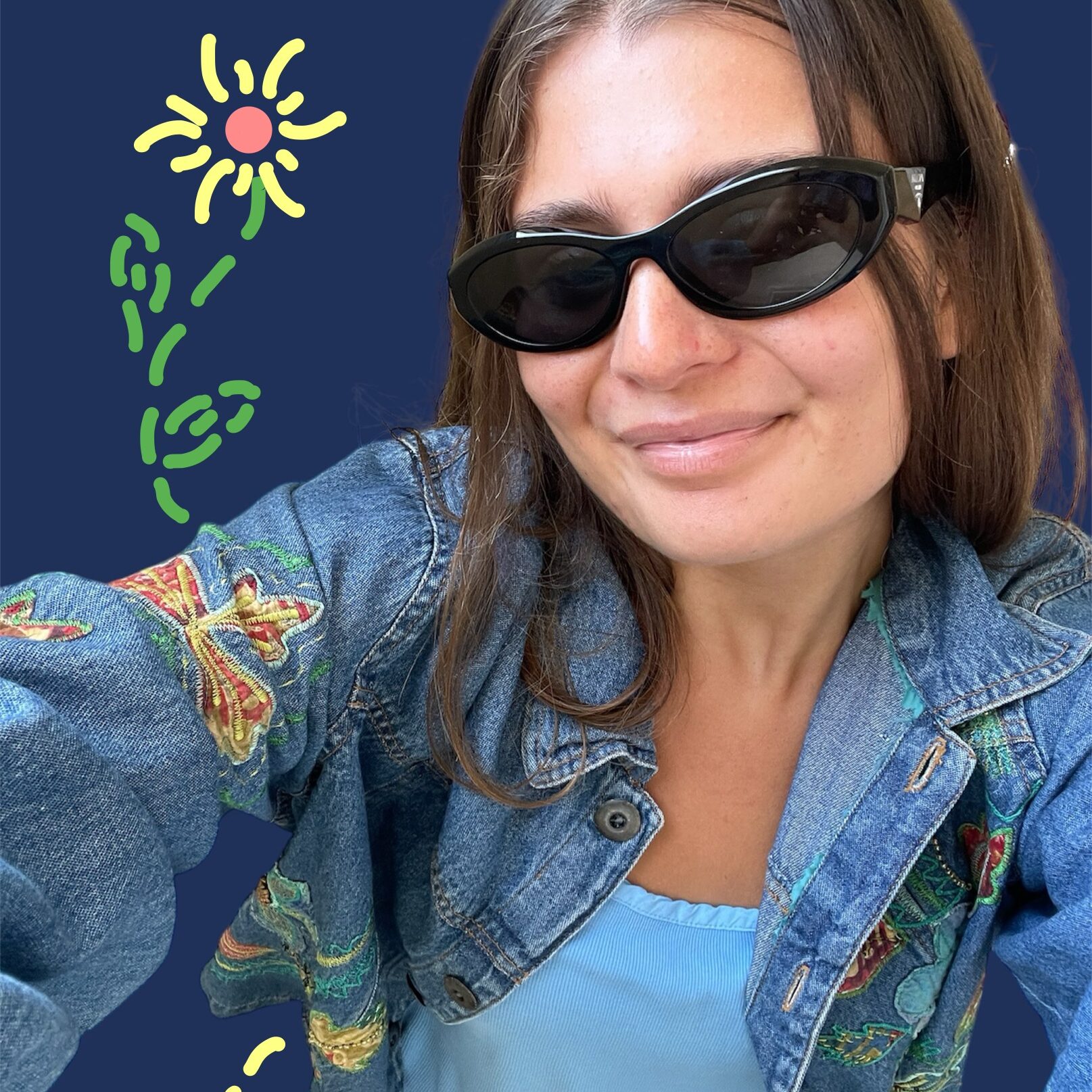 A photo of Genevieve wearing sunglasses with brightly colored doodles of a flower