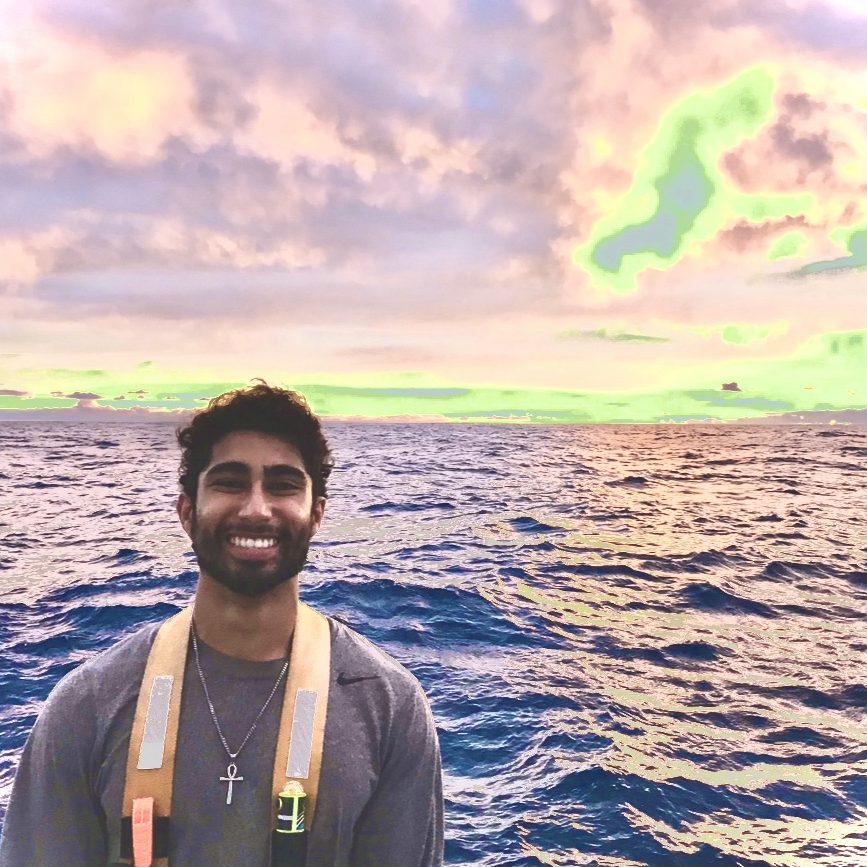 Photo of Matt Mettias, with the ocean in the background, bright sky colors