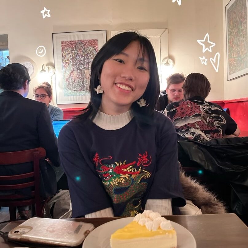 A photo of Katherine in front of a slice of pie with little doodles around her head