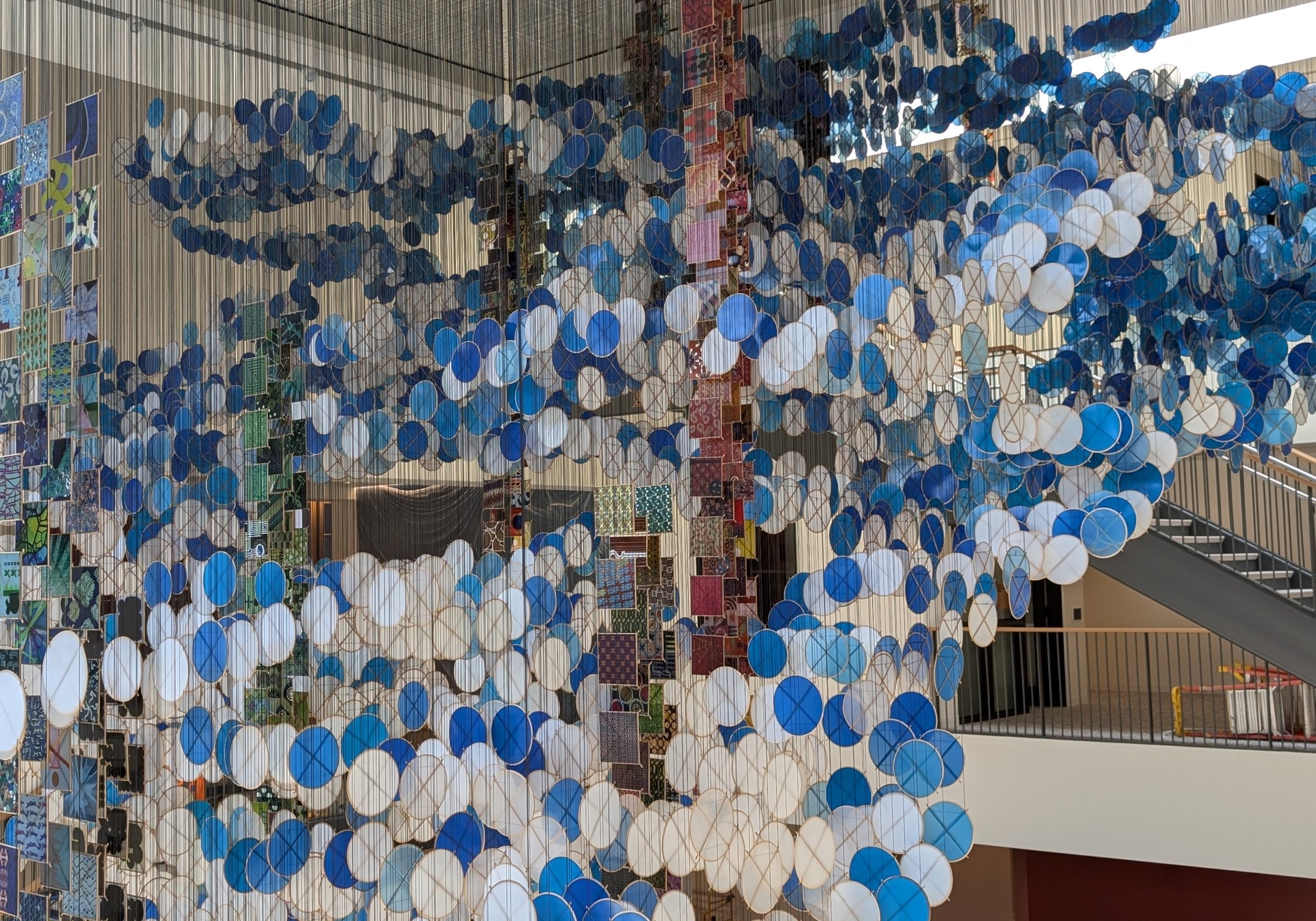 Hanging sculpture with kites and resin windows inside a Stanford GSE building