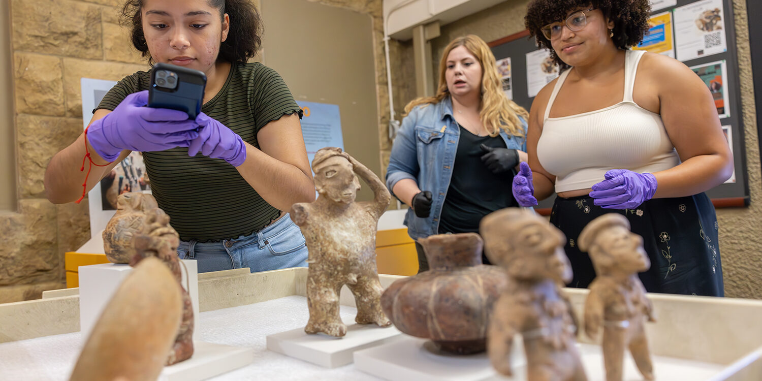 Student curators prepare Tumbas De Tiro exhibit for the SUAC Exhibition  "De la Tierra: Indigenous Ceramics from West Mexico Transcending Time and Space” at the Stanford Archaeology Center at Stanford University in Palo Alto, CA on Tuesday, May 28, 2024.  Photographer: LiPo Ching/Stanford University

IDs, from left to right:
1) Karen Rojas, Student Curator, Junior, Archeology and Human Biology Major
2) Veronica Jacobs-Edmondson
Senior Collections Assistant
SUAC - Stanford University Archeology Collections 
3) Alana Okonkwo Student Curator, Sophomore, Archeology and African &amp; African American Studies

EXHIBIT INFO:
Tumbas De Tiro, Shaft Tomb
Underground burial rooms to honor ancestors
Funerary objects on display