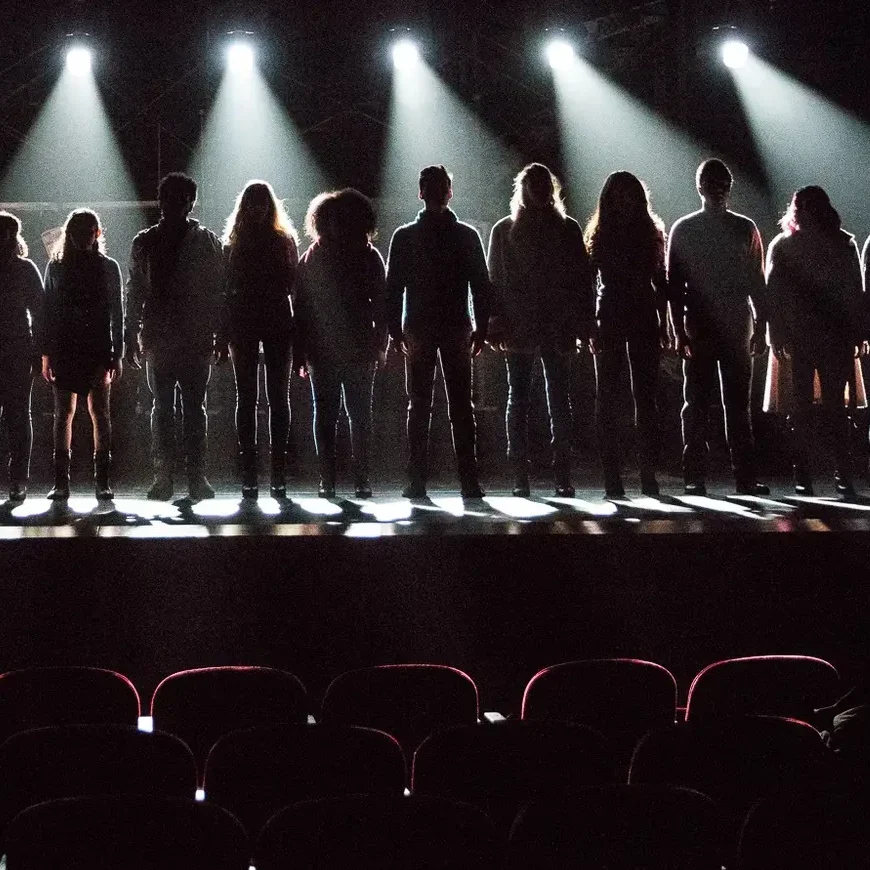 Students on stage taking a bow.